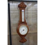 AN OAK CASED WALL HANGING BAROMETER