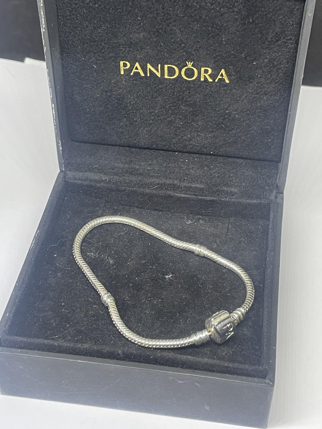 A SILVER PANDORA BRACELET IN A PRESENTATION BOX