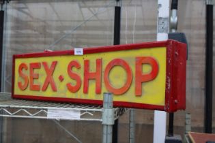 AN ILLUMINATED SEX SHOP SIGN