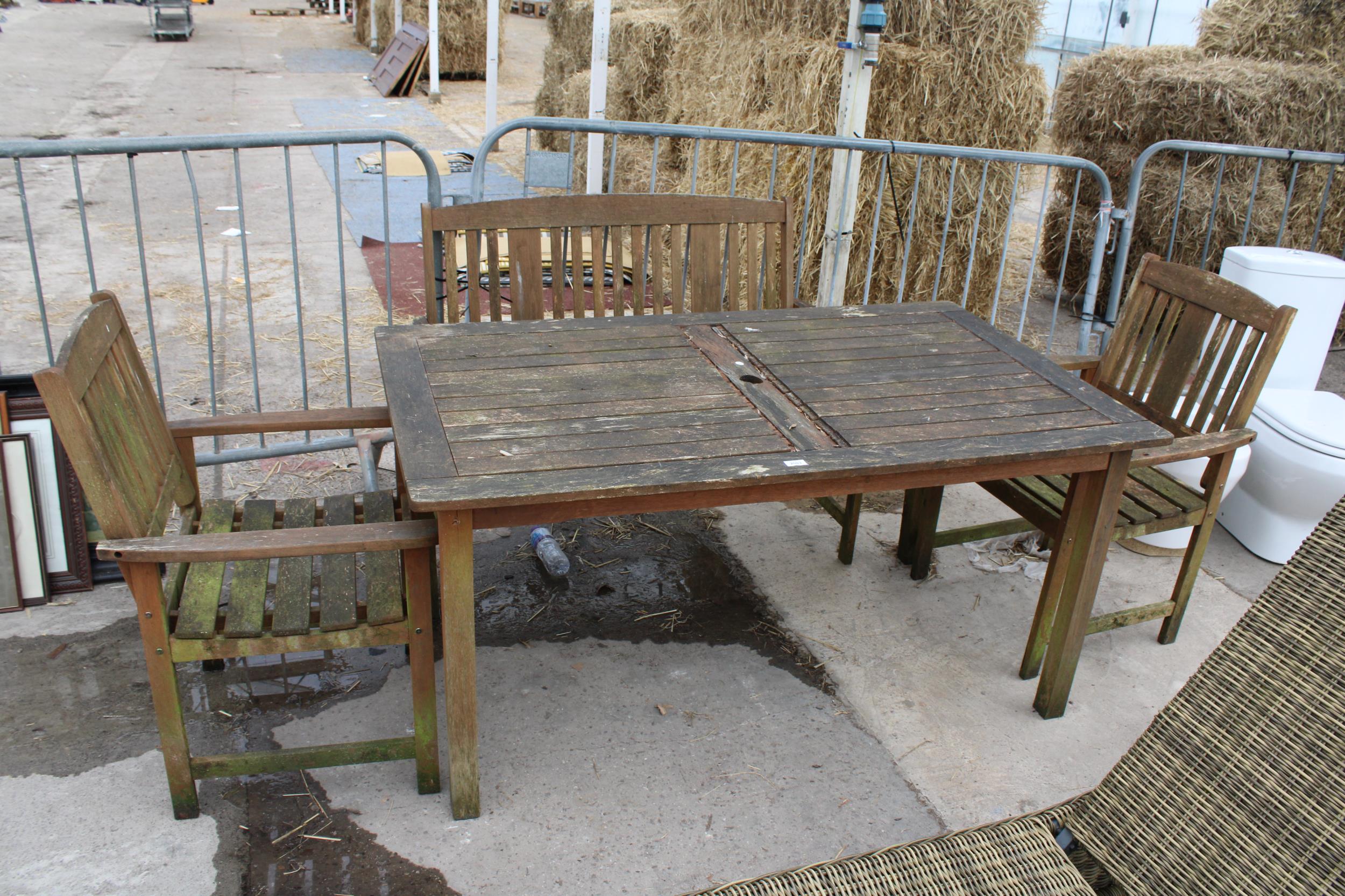 A TEAK GARDEN TABLE WITH A BENCH AND TWO CHAIRS