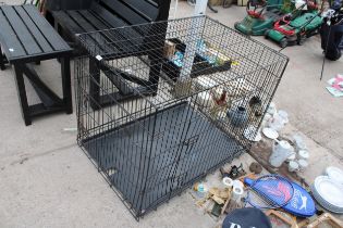 A LARGE METAL FOLDING DOG CAGE