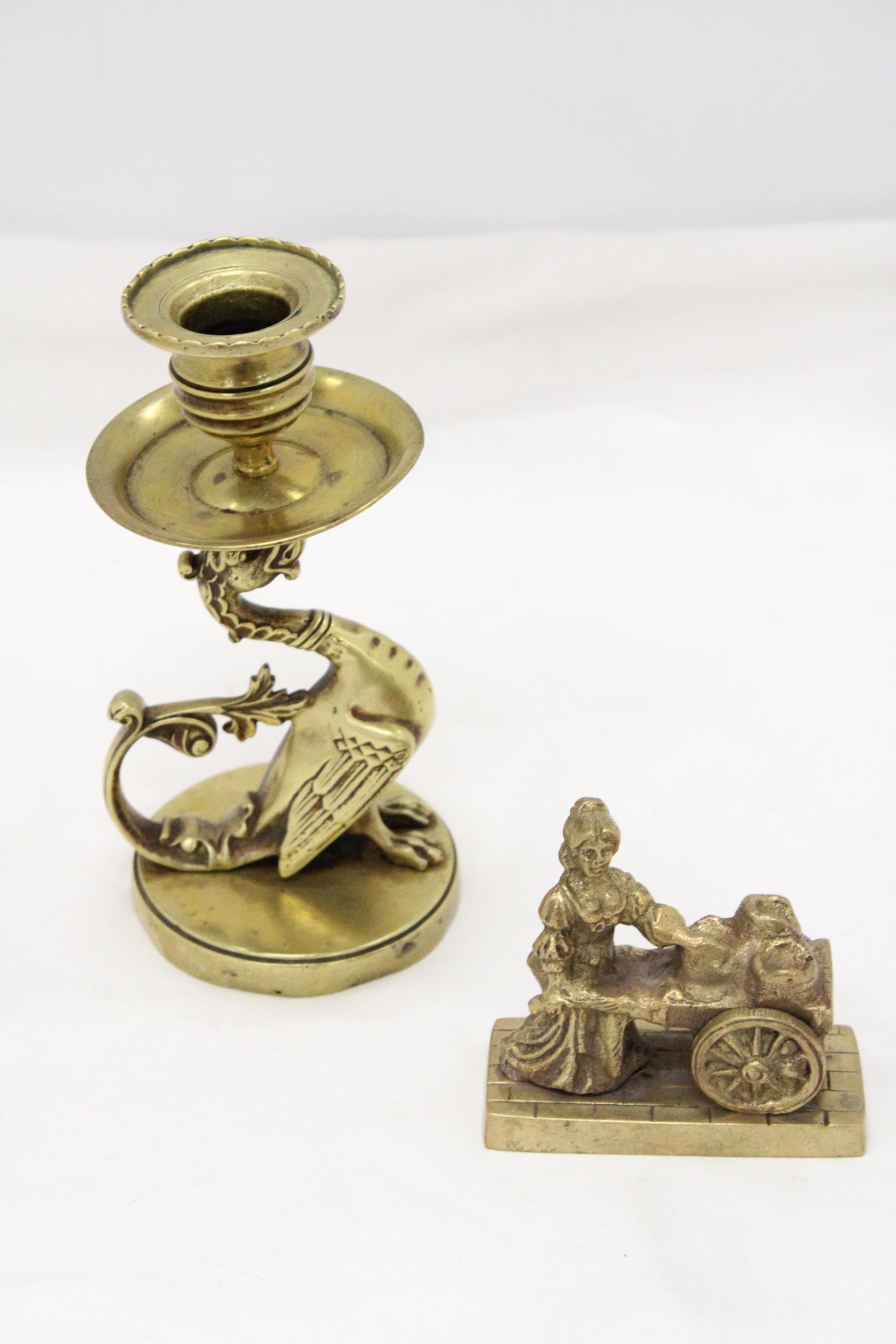 A VINTAGE BRASS GRYPHON CANDLESTICK PLUS A MOLLY MALONE FIGURE