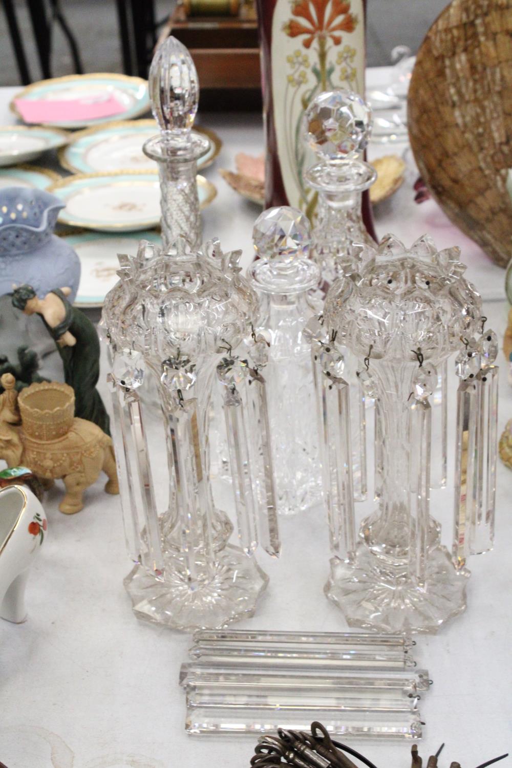 A COLLECTION OF GLASSWARE TO INCLUDE THREE GLASS DECANTERS PLUS A PAIR OF CUT GLASS LUSTRES (A/F)