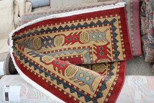 A BELIEVED AS NEW MADE IN TURKEY BLUE AND RED PATTERNED RUG (245CM x 335CM)