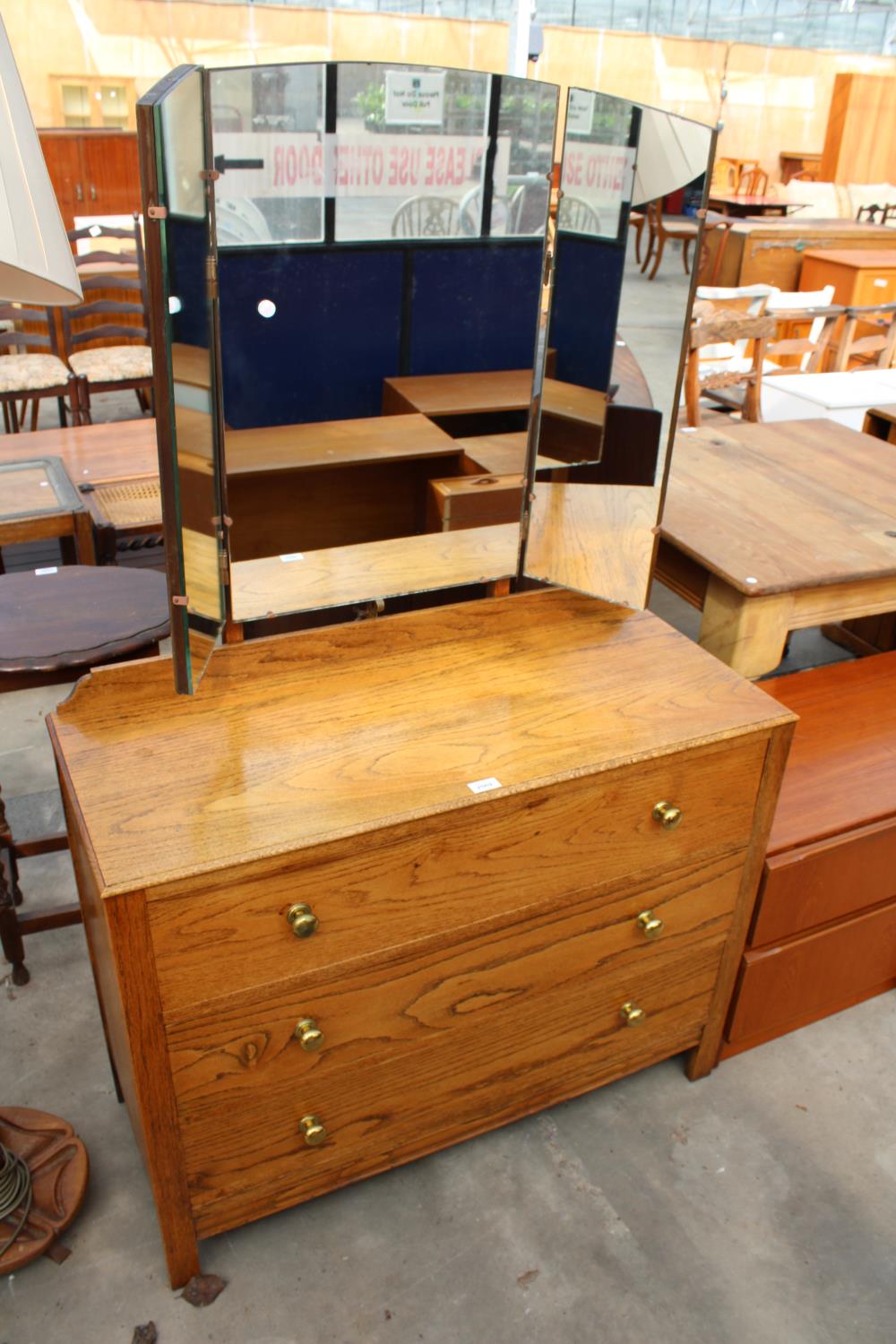 A MID 20TH CENTURY OAK THREE DRAWER DRESSING CHEST WITH TRIPLE MIRROR, 39" WIDE