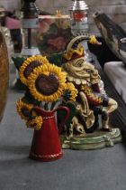 TWO CAST DOORSTOPS, A MR PUNCH AND SUNFLOWERS