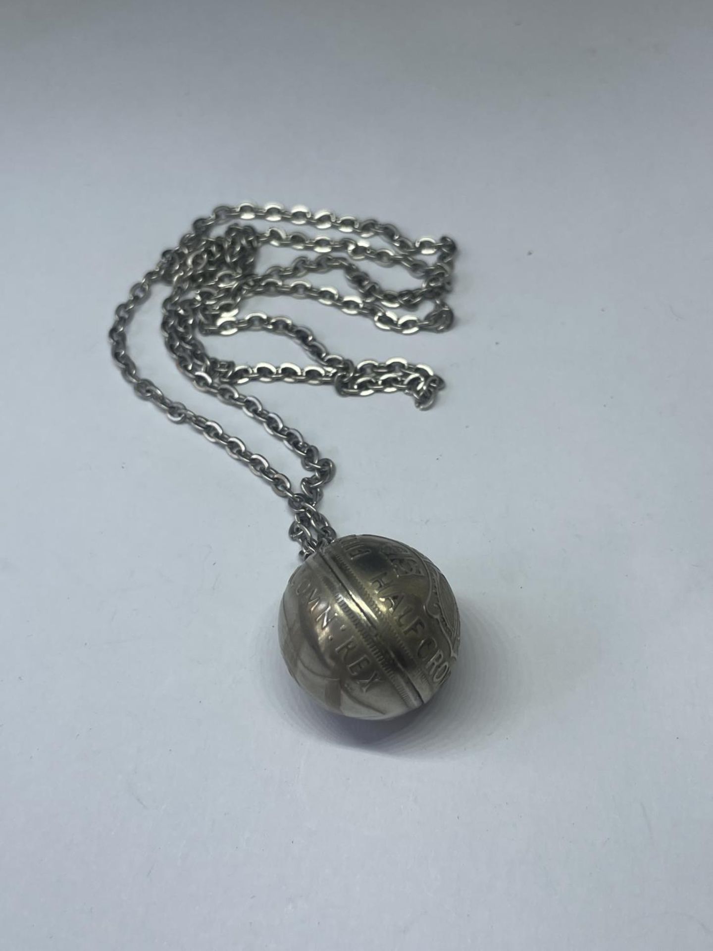 A SILVER NECKLACE AND A HALF CROWN BALL PENDANT