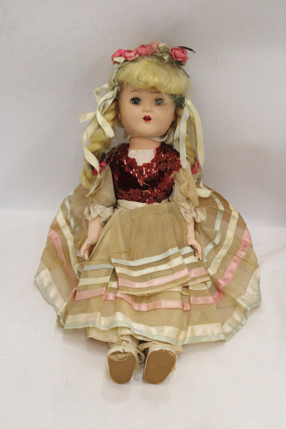 A VINTAGE DOLL WITH ORIGINAL COSTUME AND SLEEPY EYES