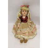 A VINTAGE DOLL WITH ORIGINAL COSTUME AND SLEEPY EYES