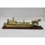 A BRASS BARGE, BARGEE AND TOW HORSE ON A WOODEN BASE, LENGTH 30CM