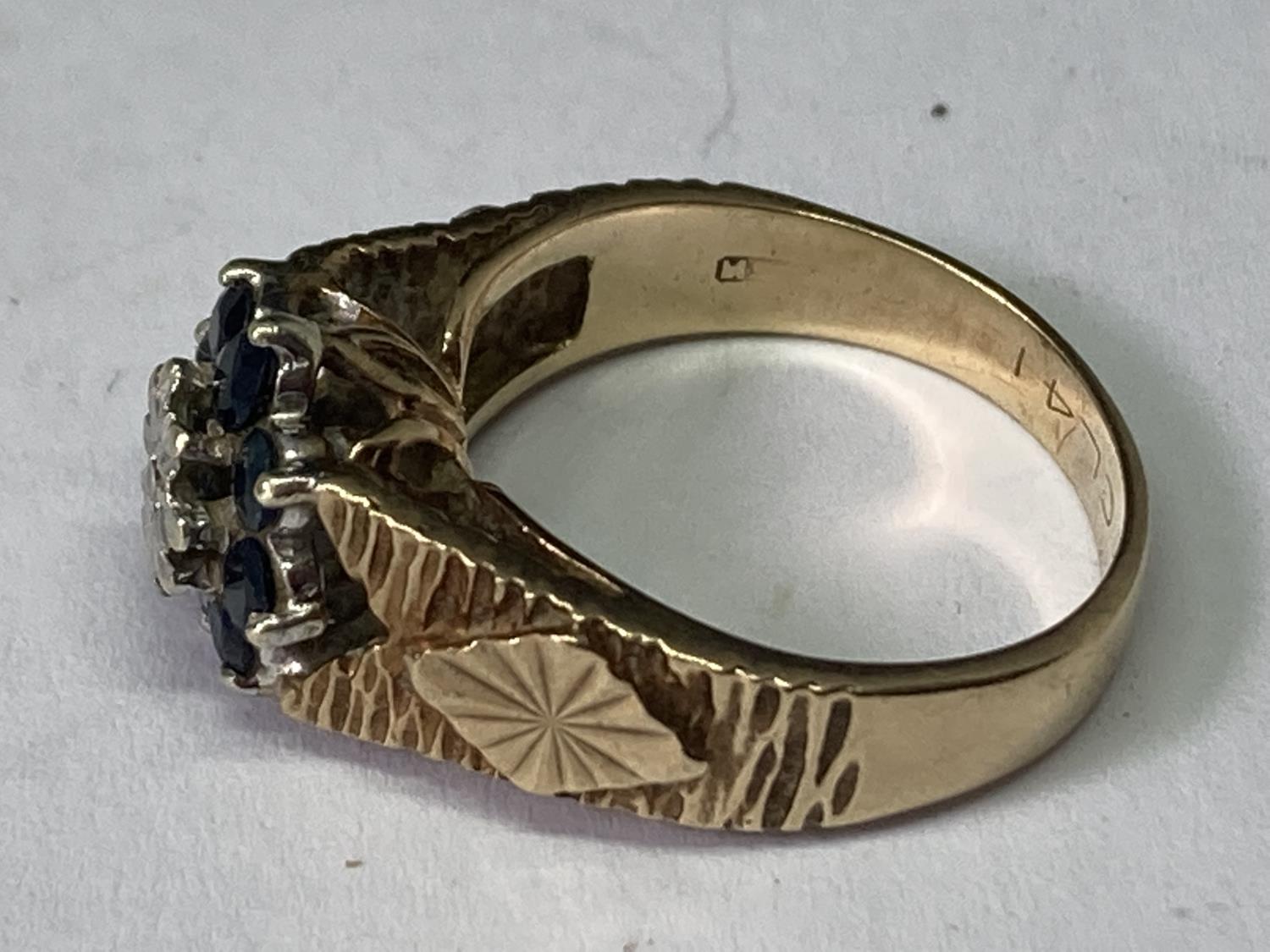 A 9 CARAT GOLD RING WITH A CENTRE DIAMOND SURROUNDED BY SAPPHIRES SIZE J - Image 2 of 4