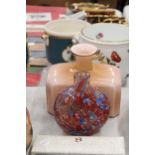 A PEACH GLASS BOTTLE VASE AND A MILLIFIORE VASE - POSSIBLY MURANO