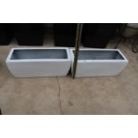 A PAIR OF WHITE LOW FIBRE GLASS TROUGH PLANTERS (H:20 L:49CM)