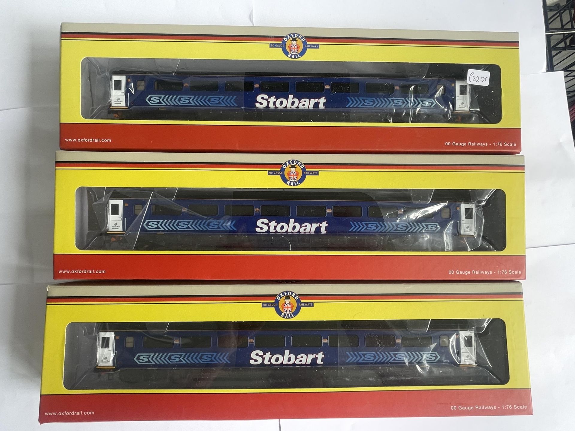 THREE BOXED OXFORD RAIL 00 GAUGE STOBART RAIL COACHES