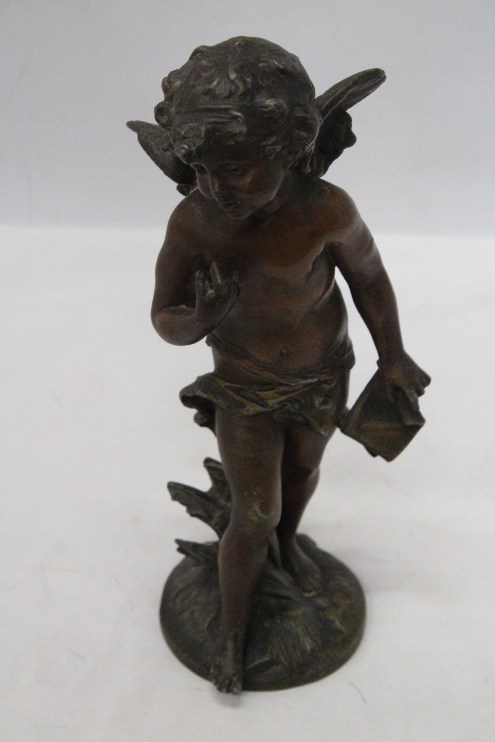 A BRONZE SCULPTURE OF A CHERUB SIGNED TO THE BASE