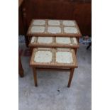 A RETRO TEAK NEST OF THREE TABLES WITH TILED TOPS, STAMPED ANBERCRAFT SHERATON HOWE