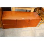 A LOW RETRO TEAK UNIT ENCLOSING TWO CUPBOARDS, TWO DRAWERS, 54" WIDE