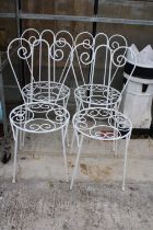 A SET OF FOUR ORNATE AND DECORATIVE METAL BISTRO CHAIRS