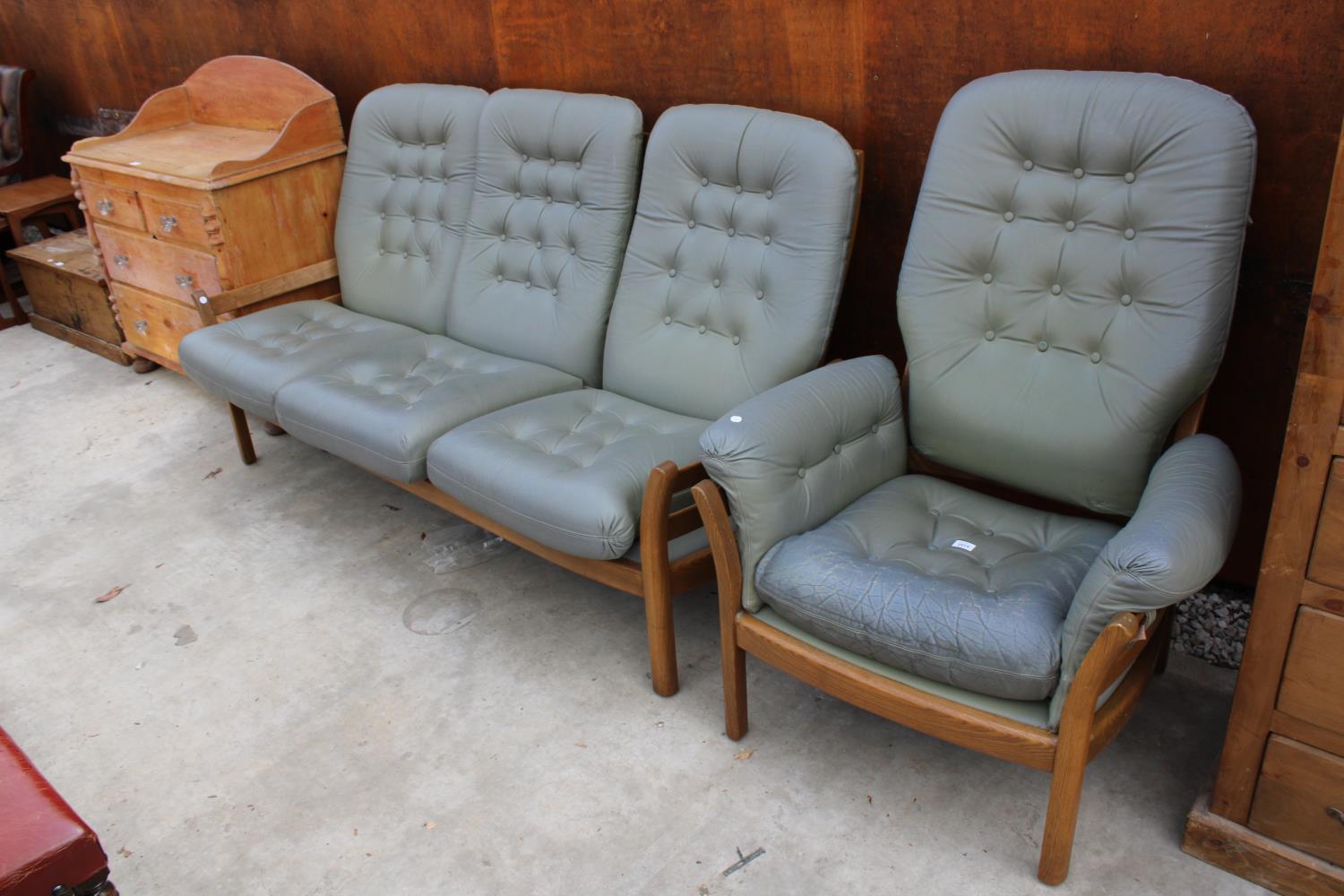 AN ERCOL THREE SEATER SETTEE AND FIRESIDE CHAIR