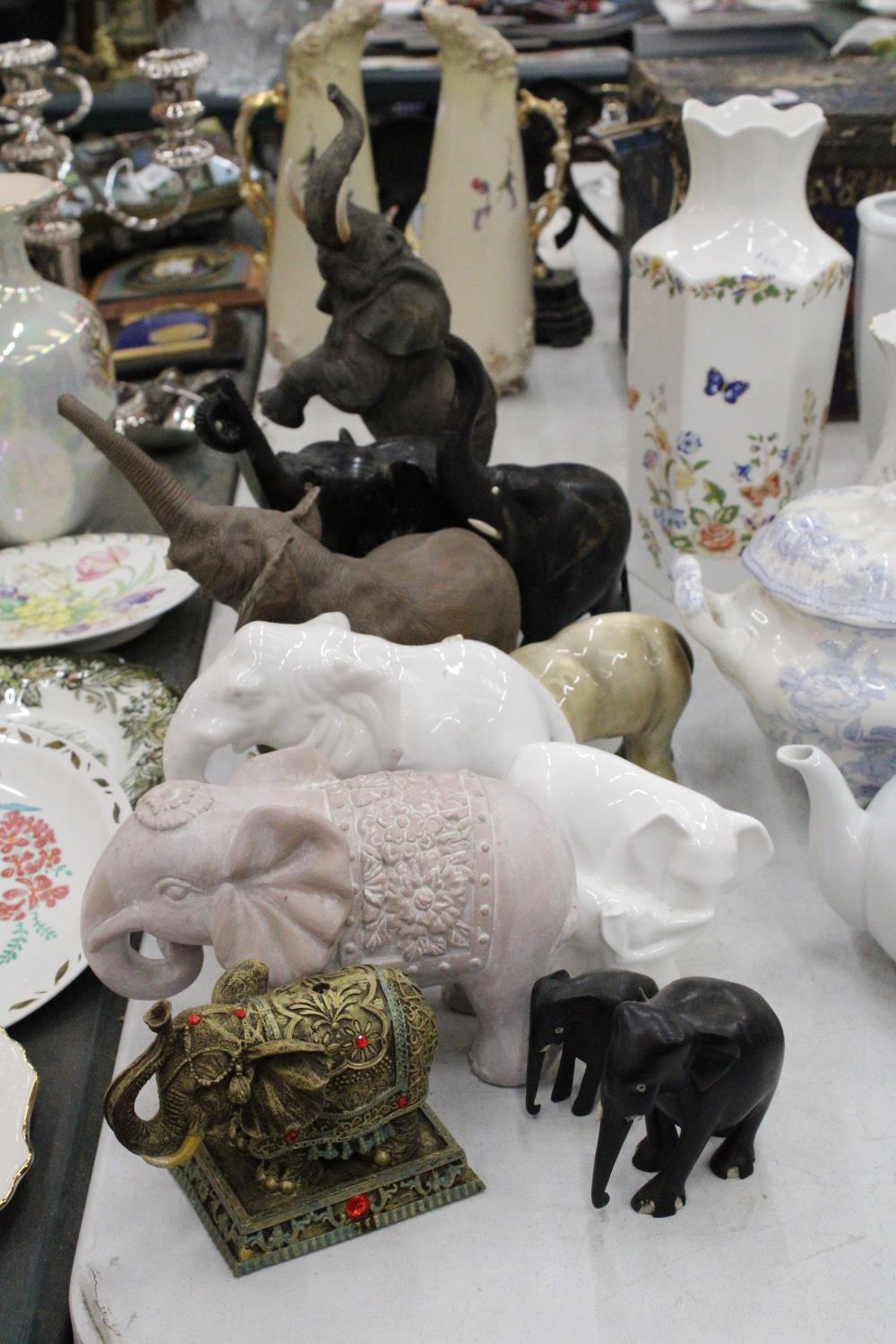 A COLLECTION OF ELEVEN ELEPHANT FIGURES INCLUDING WOODEN AND CERAMIC