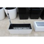 A LECHUZA LOW WHITE PLASTIC TROUGHT PLANTER WITH SELF WATERING SYSTEM (H:19CM L:50CM)