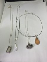 FOUR SILVER NECKLACES WITH PENDANTS