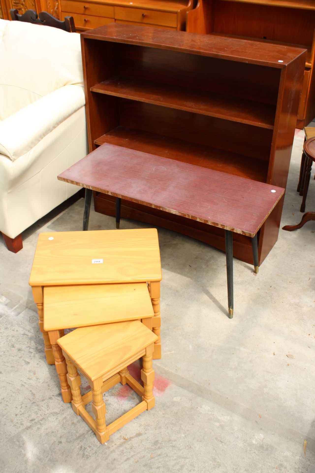 A NEST OF THREE TABLES, OPEN THREE TIER BOOKCASE AND COFFEE TABLE