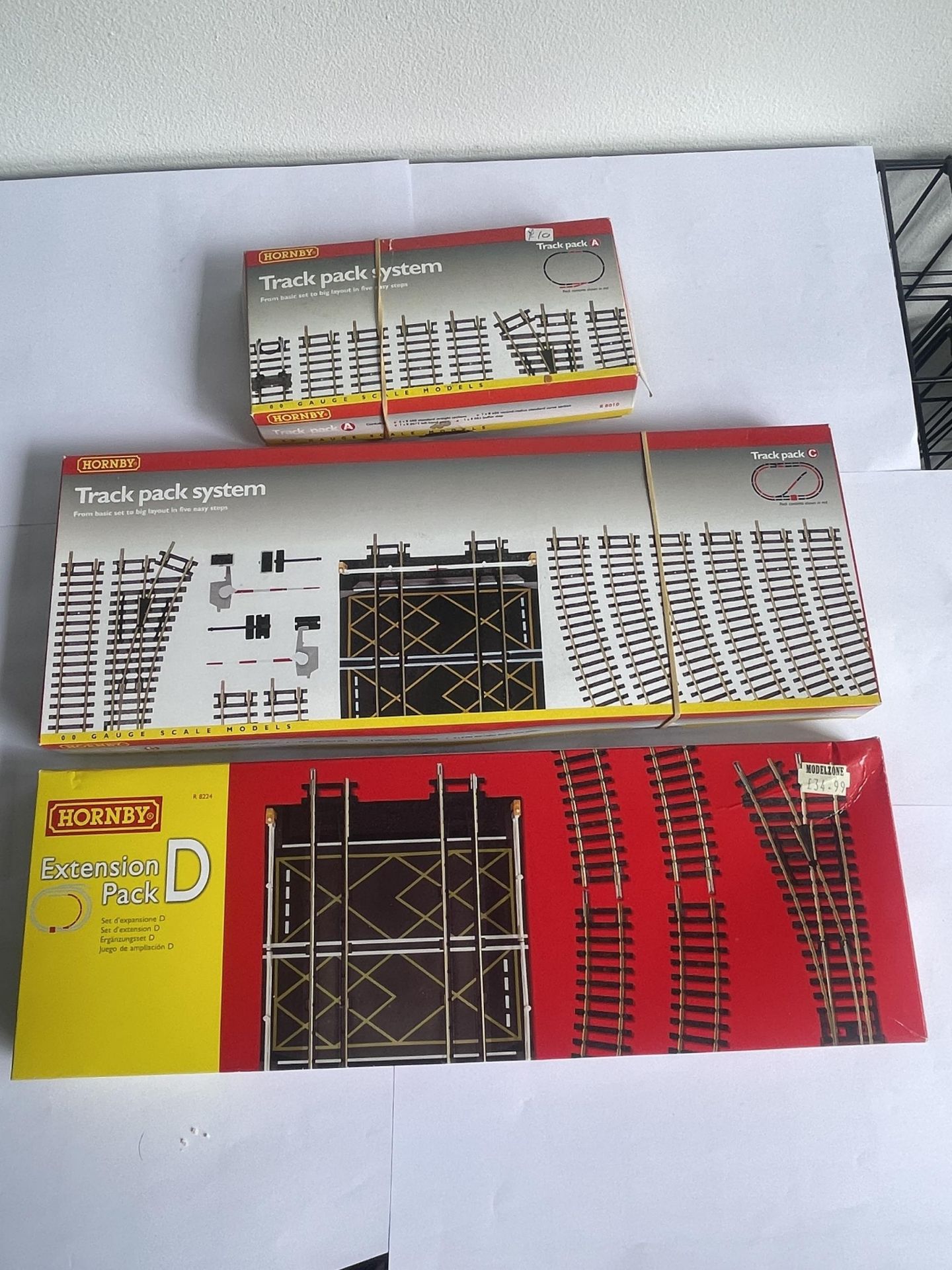 THREE BOXED HORNBY 00 GAUGE TRACK PACKS TO INCLUDE A AND C AND EXTENSION PACK D