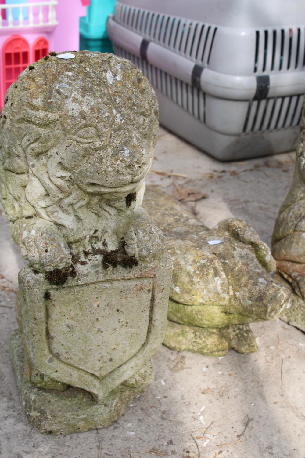 THREE RECONSTITUTED STONE GARDEN FIGURES TO INCLUDE A PAIR OF LIONS AND A PIG - Image 2 of 2