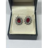 A PAIR OF SILVER AND RED STONE EARRINGS IN A PRESENTATION BOX