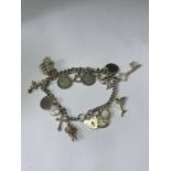 A SILVER CHARM BRACELET WITH FIFTEEN CHARMS