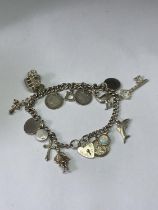 A SILVER CHARM BRACELET WITH FIFTEEN CHARMS