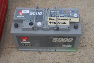 A YUASA YBX 5000 CAR BATTERY BELIEVED FULLY CHARGED AND HOLDING CHARGE BUT NO WARRANTY