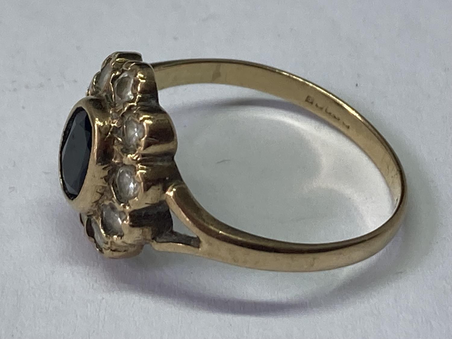 A 9 CARAT GOLD RING WITH CENTRE SAPPHIRE SURROUNDED BY CUBIC ZIRCONIAS SIZE R/S - Image 2 of 3