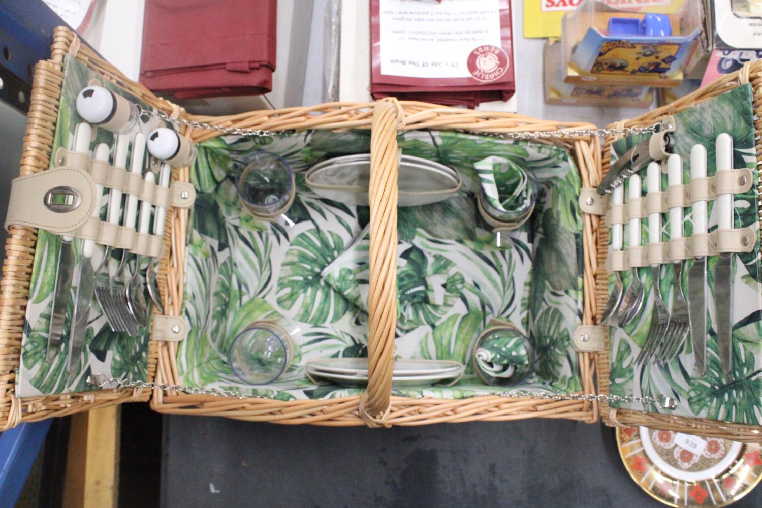 A WICKER PICNIC BASKET WITH LEAF PATTERN INTERIOR TO INCLUDE KNIVES, FORKS, SPOONS, PLATES, SALT AND - Image 4 of 7