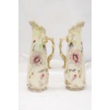 A PAIR OF VICTORIAN JUGS IN IVORY WITH FLORAL AND GILT DECORATION - APPROXIMATELY 31CM HIGH