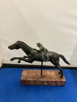 A BRONZE FIGURE OF A YOUNG BOY ON A RACE HORSE DEPICTING THE JOCKEY OF ARTEMISION ON A MARBLE BASE