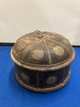 A VINTAGE INDIAN ROUND WOODEN OPIUM/TOBACCO BOX DECORATED WITH HAMMERED METAL FLOWERS