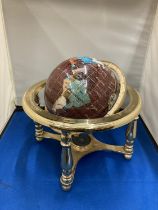 A SEMI PRECIOUS STONE GLOBE ON A BRASS STAND WITH COMPASS