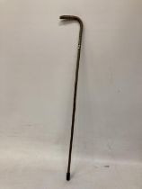A WOODEN WALKING CANE WITH A HALLMARKED SILVER FINIAL