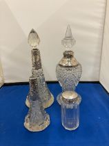 FOUR GLASS AND SILVER BOTTLES AND JARS THREE WITH HALLMARKED COLLARS AND ONE WITH HALLMARKED LID