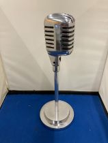 A CHROME MICROPHONE ON A STAND