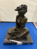 A BRONZE SITTING LADY FIGURE ON A MARBLE BASE