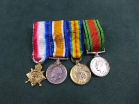 A WORLD WAR I MINIATURE MEDAL TRIO AND WORLD WAR II DEFENCE MEDAL