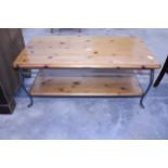 A PINE TWO TIER COFFEE TABLE ON SHAPED METALWARE FRAME, 43" X 22"