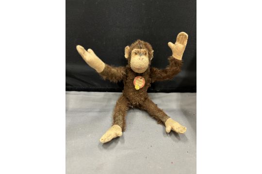 A VINTAGE STEIFF JOCKO MONKEY WITH EAR BUTTON AND LABEL - Image 1 of 4