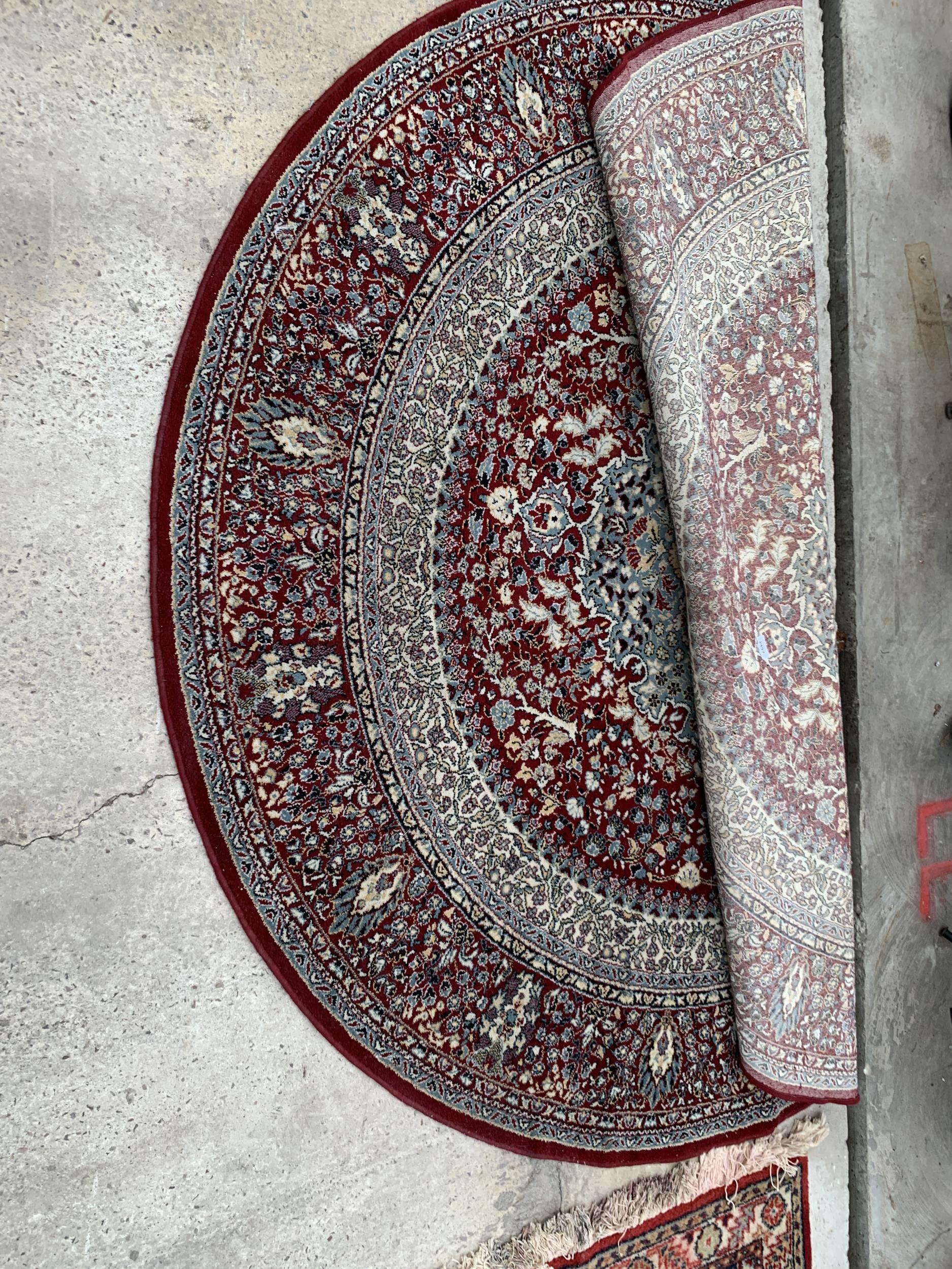 A CIRCULAR RED PATTERNED RUG