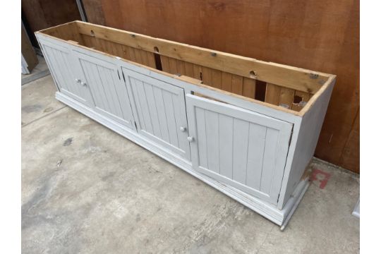 A PAINTED PINE BASE UNIT, 102" WIDE, ENCLOSING FOUR CUPBOARDS - Image 1 of 3