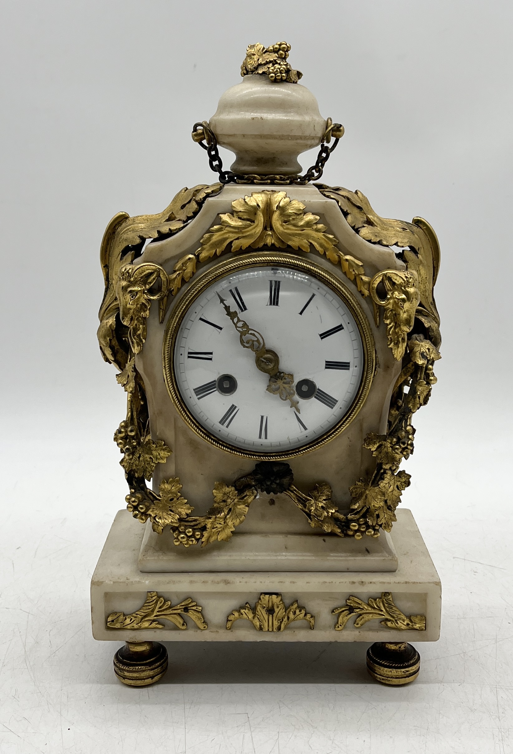 A French alabaster and ormolu mantle clock on bun feet (one part loose but present)