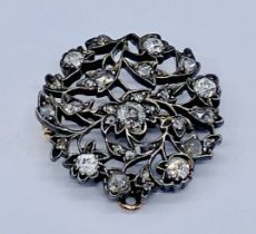 A Georgian floral design brooch set with numerous mine cut diamonds, the central stone measuring